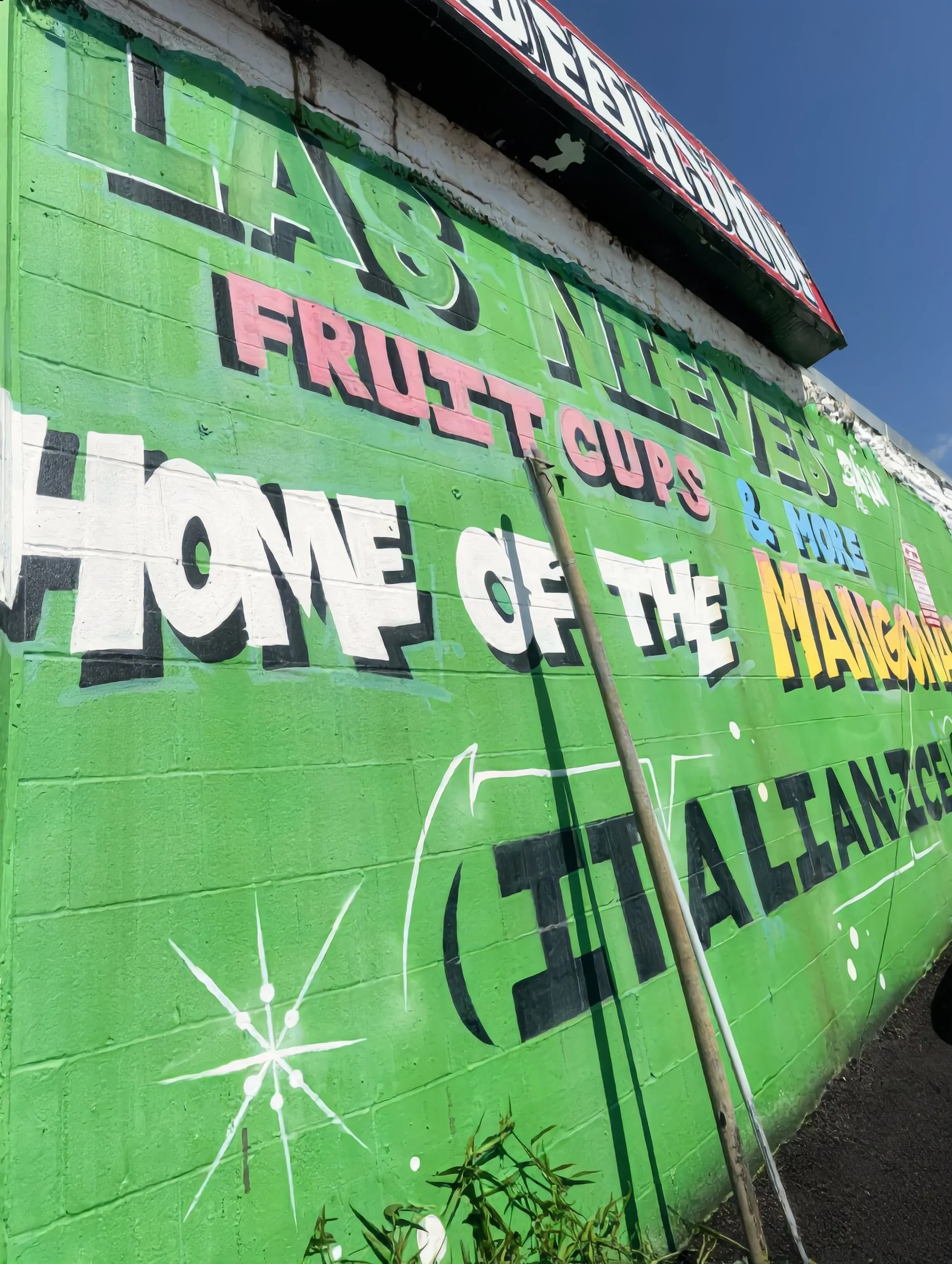 The hand-painted “Home of the Mangonada” mural on the Las Nieves stand