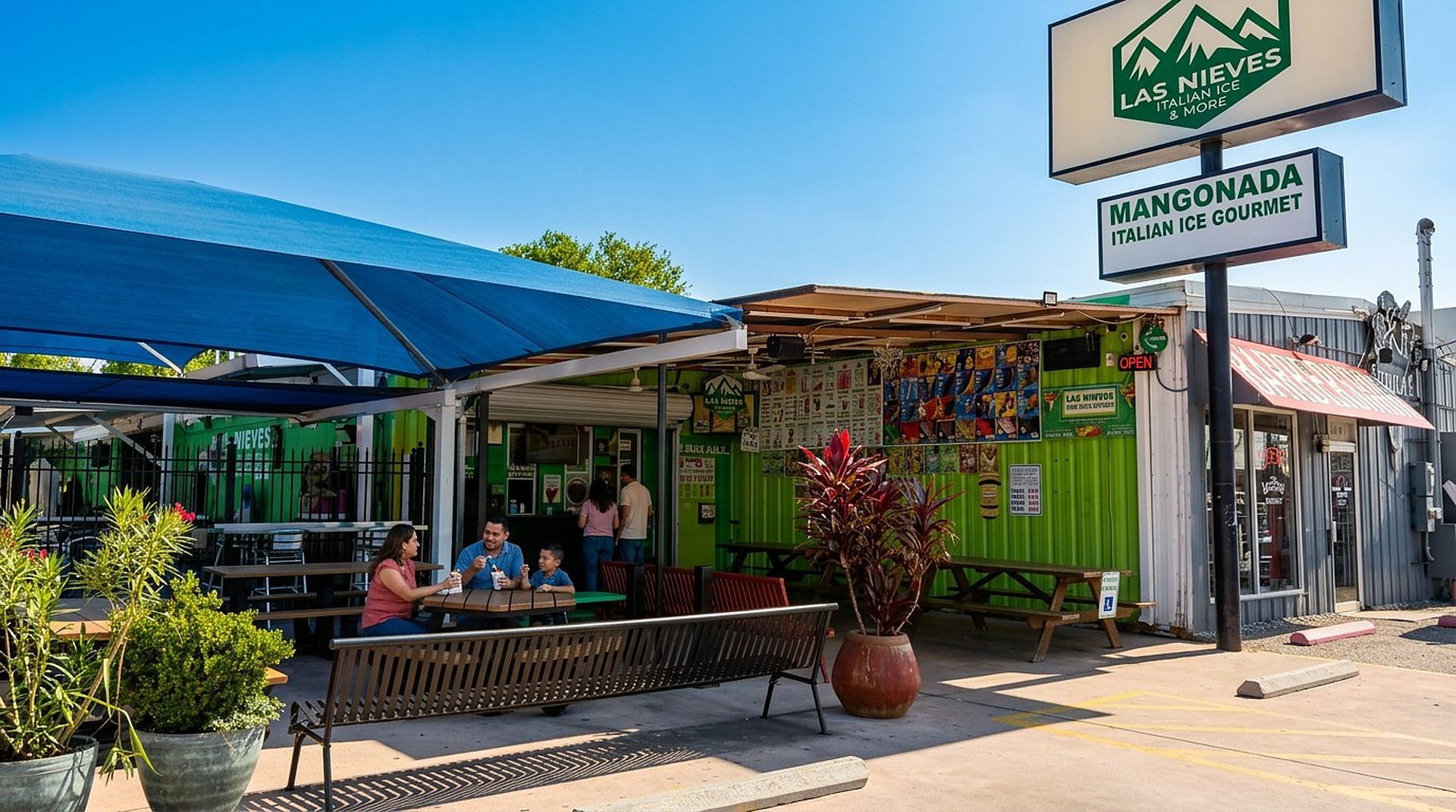 The Las Nieves storefront in San Antonio — the LAS NIEVES sign, green building, shaded patio and Mangonada / Italian Ice Gourmet