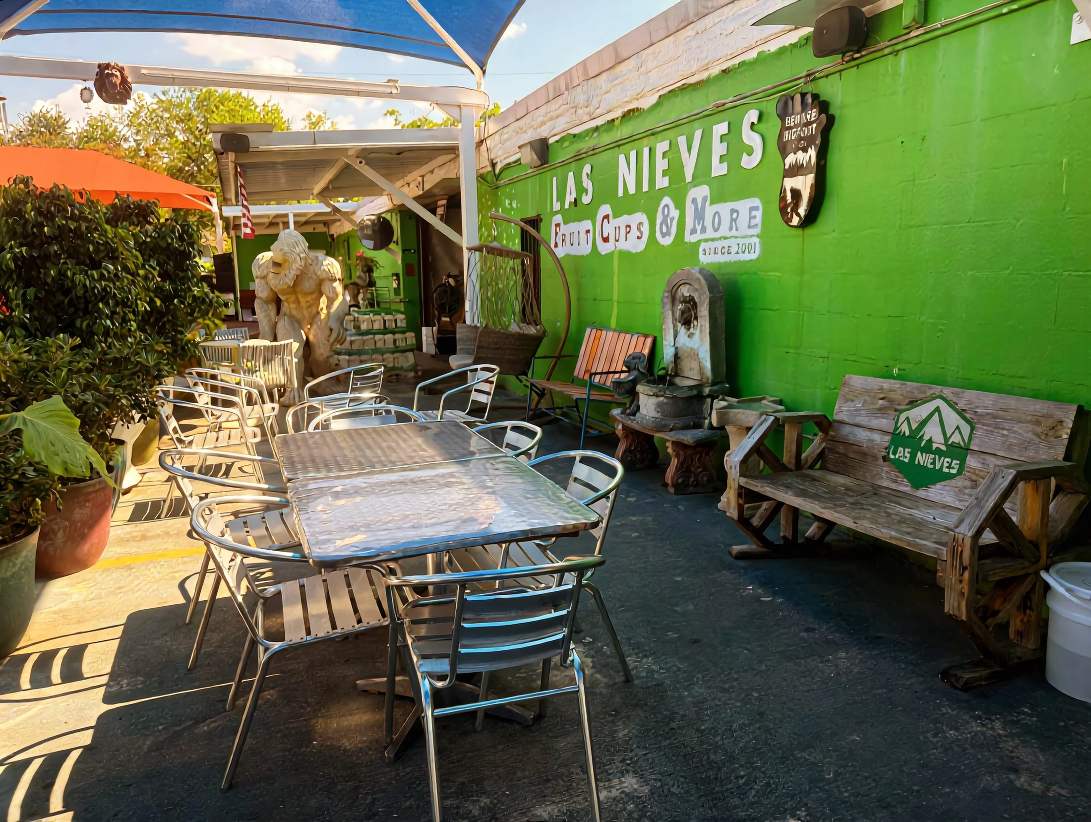 The Las Nieves patio — the 'Since 2001' wall, the logo bench and the Bigfoot mascot